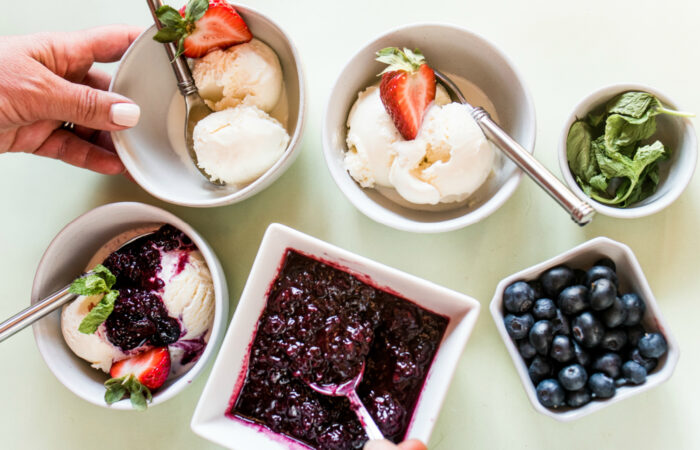 making ice cream sundaes with berry compote