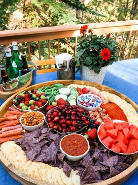 epic round board filled with red, white and blue charcuterie foods