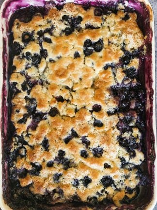 close up of blueberry cobbler with light brown doughy crust