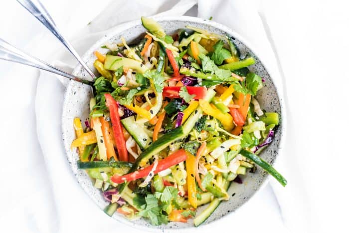 a bowl of mango cucumber summer slaw