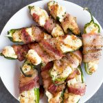 a white plate of Bacon-Wrapped Air Fryer Cheesy Jalapeño Poppers