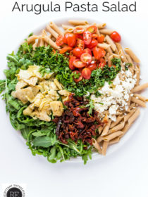 round plate of arugula pasta salad ingredients