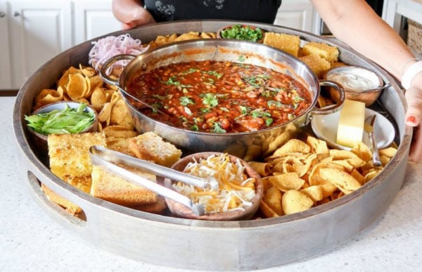 holding an epic chili dinner board