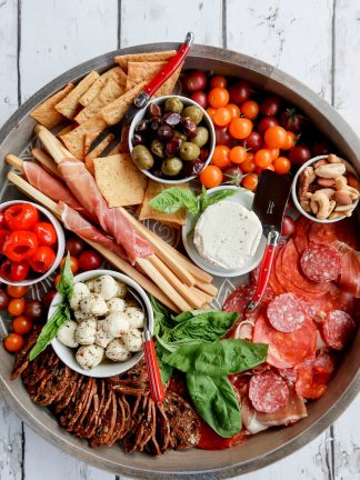 round charcuterie board with cured meats and cheese