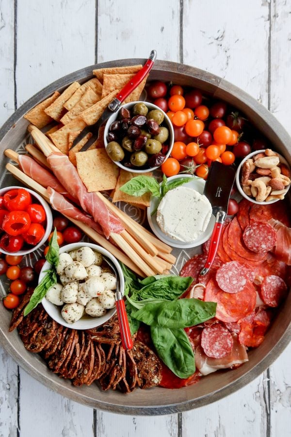 round charcuterie board with cured meats and cheese