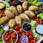 baked russet potatoes on potato board