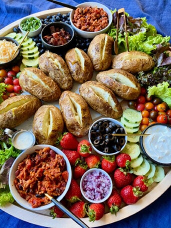 baked russet potatoes on potato board