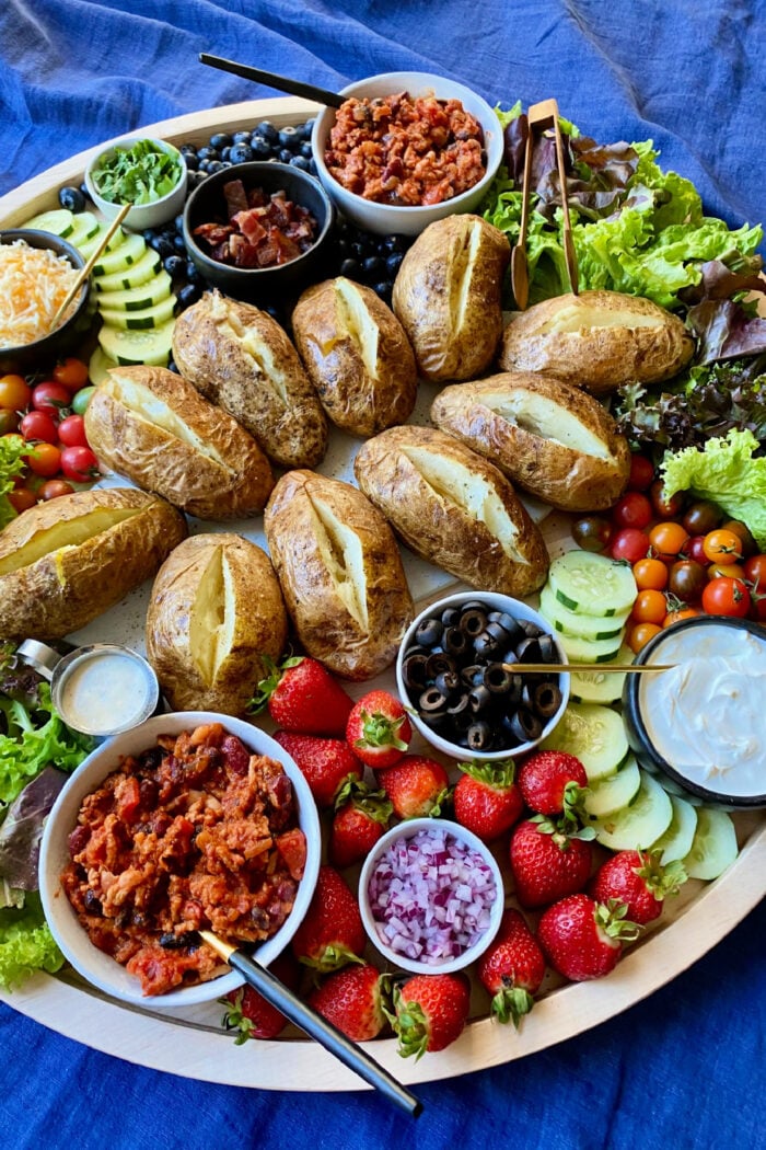 baked russet potatoes on potato board