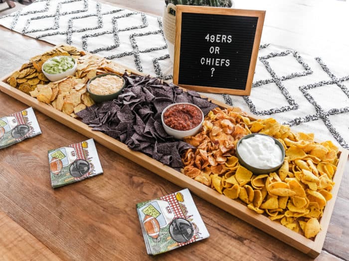 a party rectangular 42 x 12 inch board filled with chips and dips