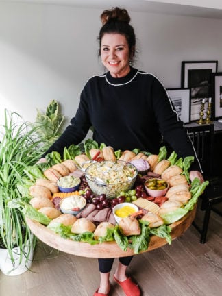 woman holding an epic roast beef sandwich board