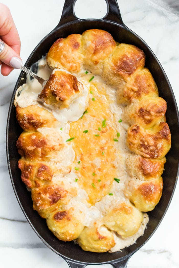 overhead shot of a plate of pretzel bites with cheese on top