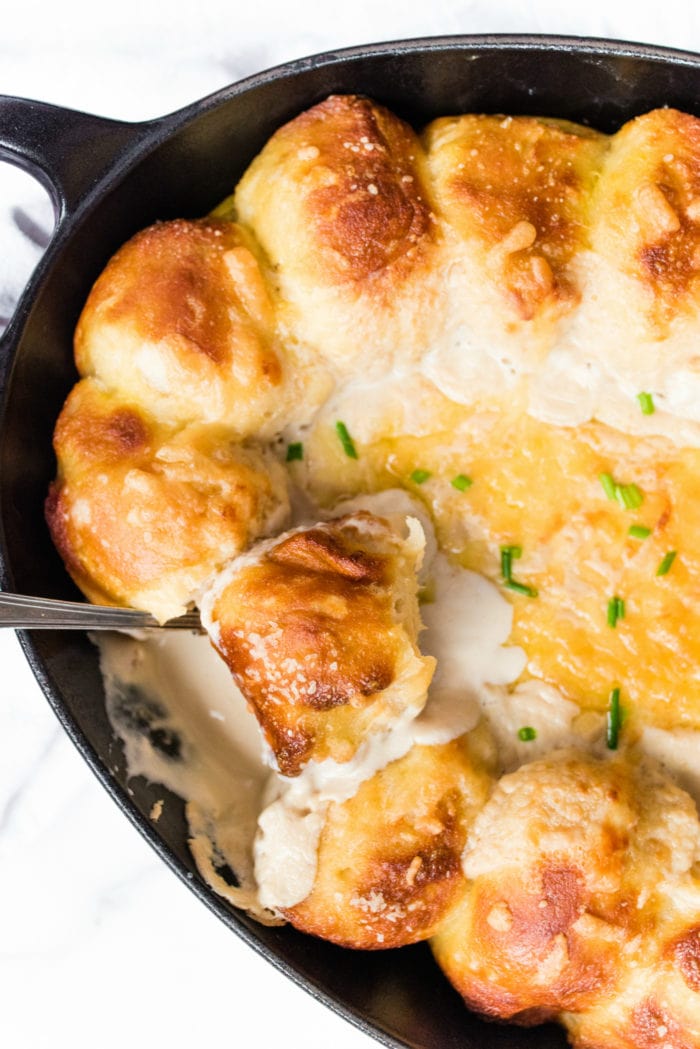 overhead shot of a plate of pretzel bites with cheese on top