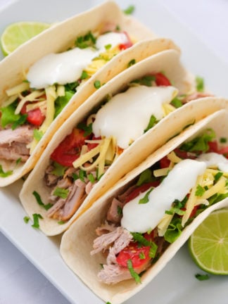 2-Ingredient Crock Pot Pork Verde served in tacos