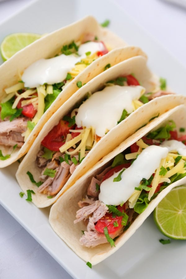 2-Ingredient Crock Pot Pork Verde served in tacos