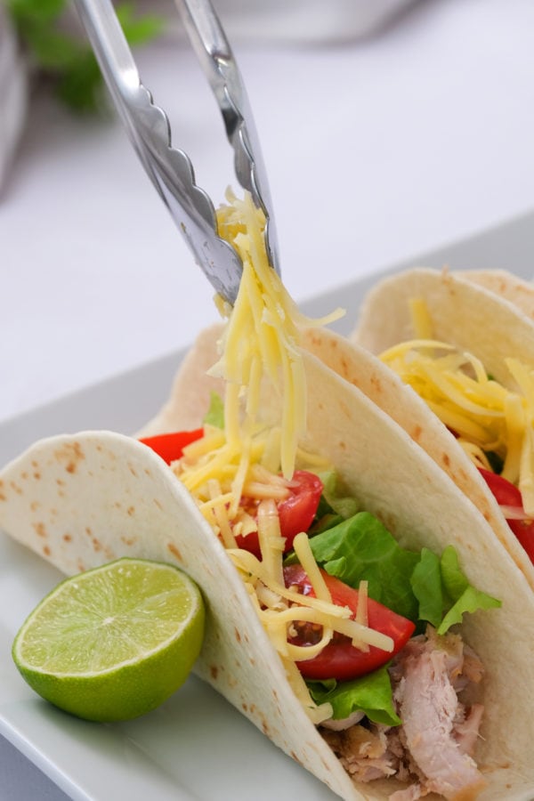 adding cheese to 2-Ingredient Crock Pot Pork Verde tacos