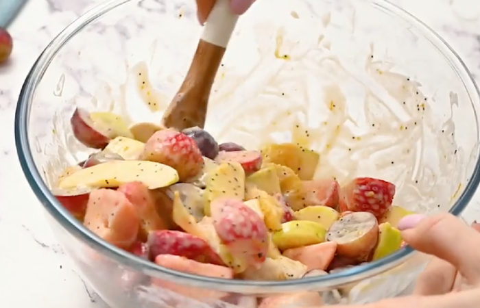 mixing fruit salad