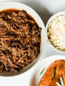 bowl of shredded instant pot chuck roast with sweet potatoes and a bowl of cheese