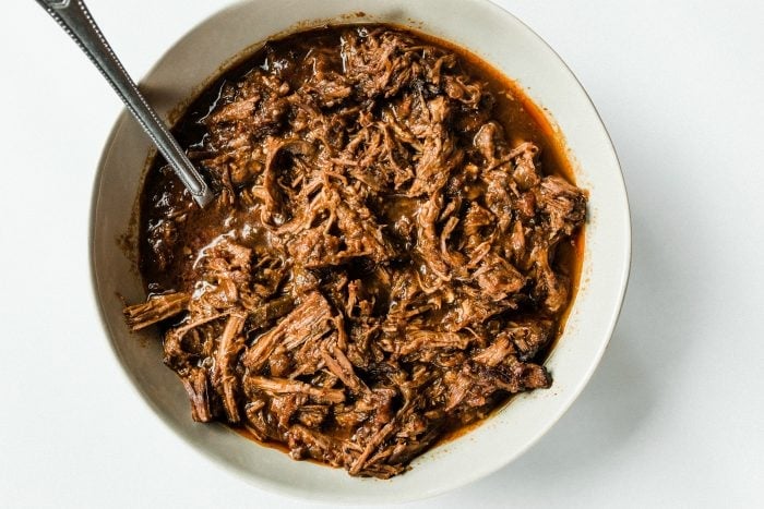 Bowl of cooked chuck roast with barbecue sauce