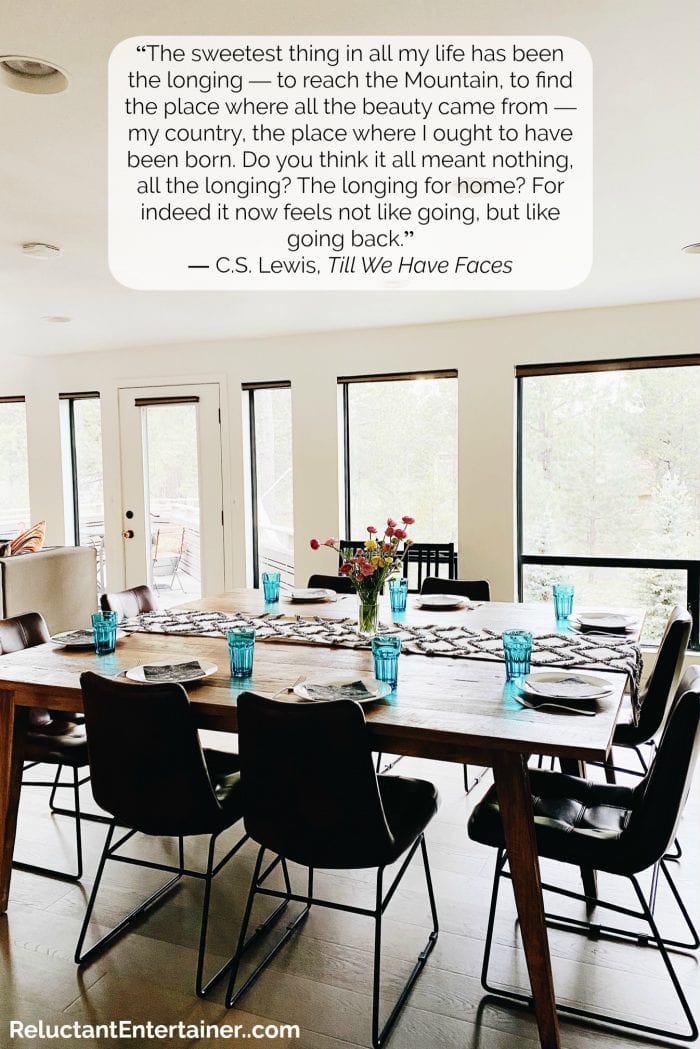 dining table with chairs set for dinner with CS Lewis quote