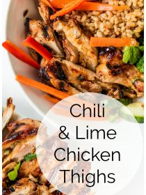 close up of grilled chili lime chicken thighs cut into long pieces, with strips of bell peppers