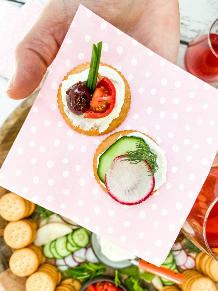 round crackers with soft cheese and veggie slices