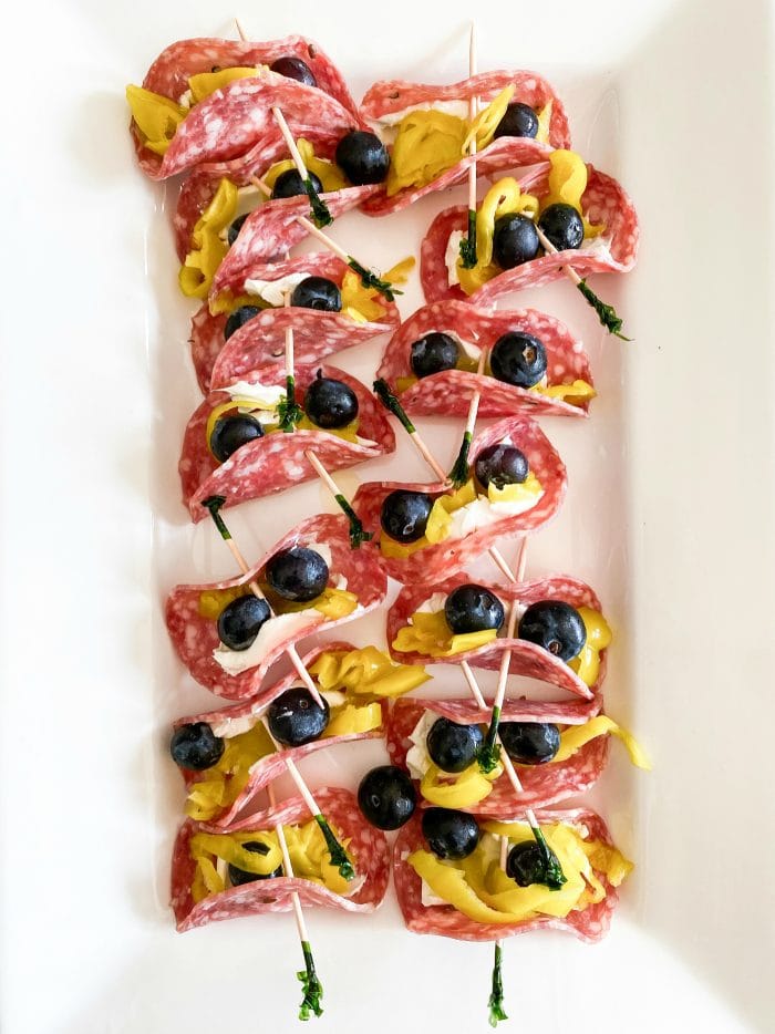 white platter filled with 13 salami pepperoncini rollups