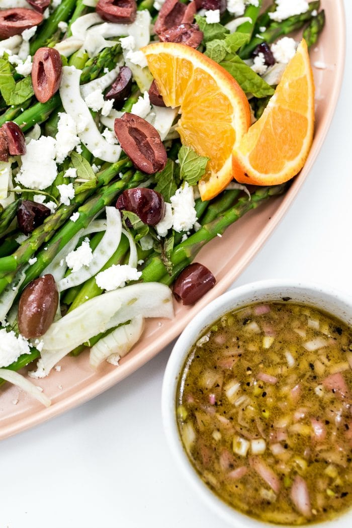 Shaved Fennel Asparagus Salad with small bowl of orange dressing