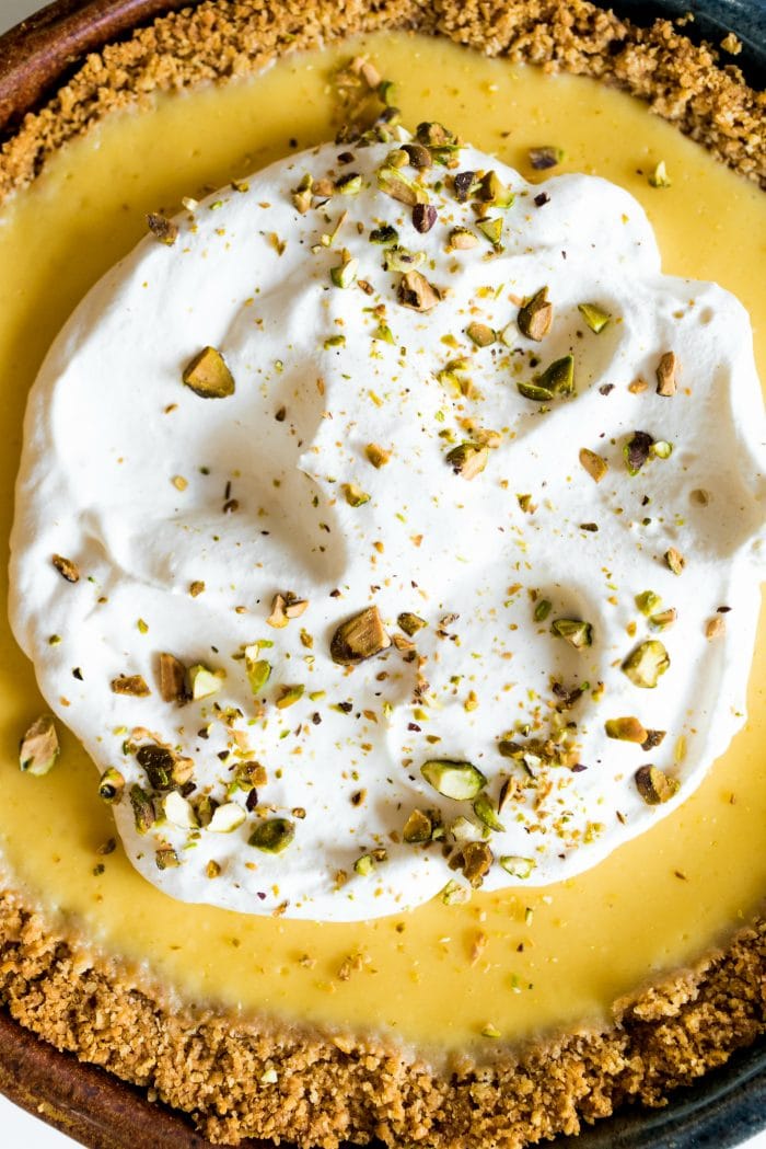 close up of a ricotta lemon pie with fresh whipped cream