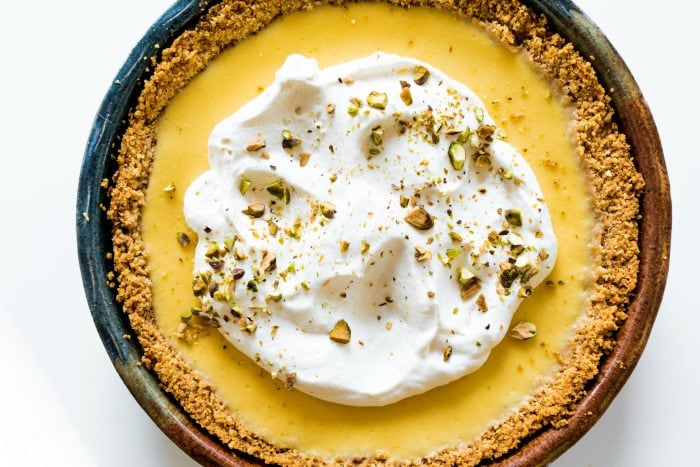 a whole lemon ricotta pie with fresh whipped cream