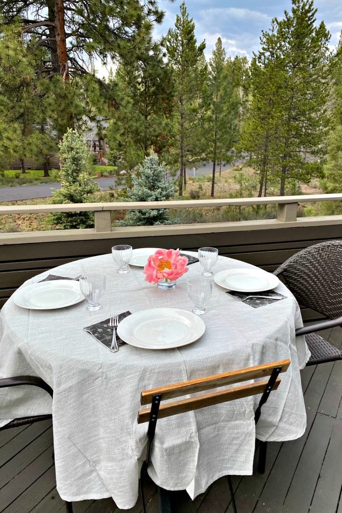 round table with 4 settings and pink peony in the center