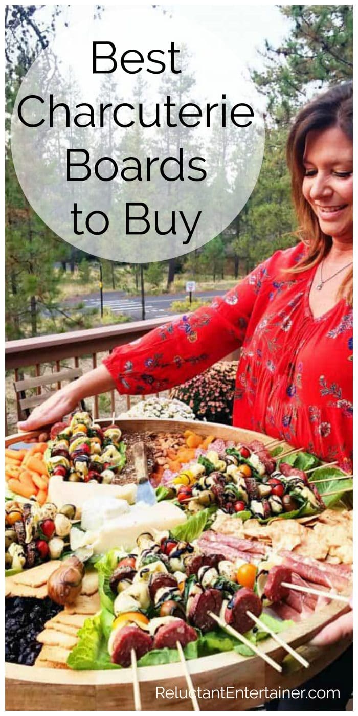 woman in red shirt holding an epic wood board with appetizers