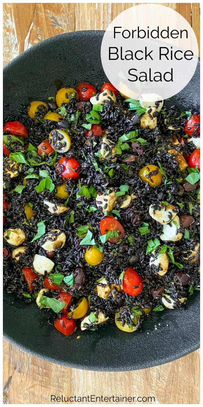 close up black rice salad with tomatoes, basil, cheese