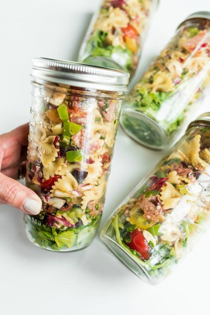 a close up filled canning jar of pasta salad (with a lid)