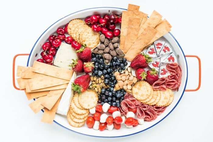 oval cheese tray with crackers and red, white, and blue foods