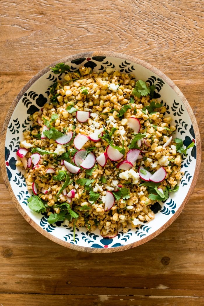 a round bowl of Mexican Street Corn Salad ready for serving