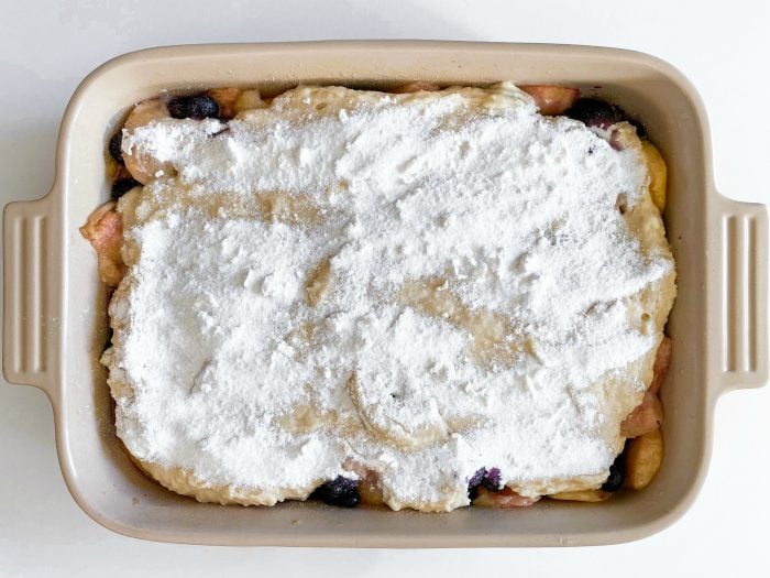 blueberry and peach cobbler topping, uncooked in 9 x 13 pan