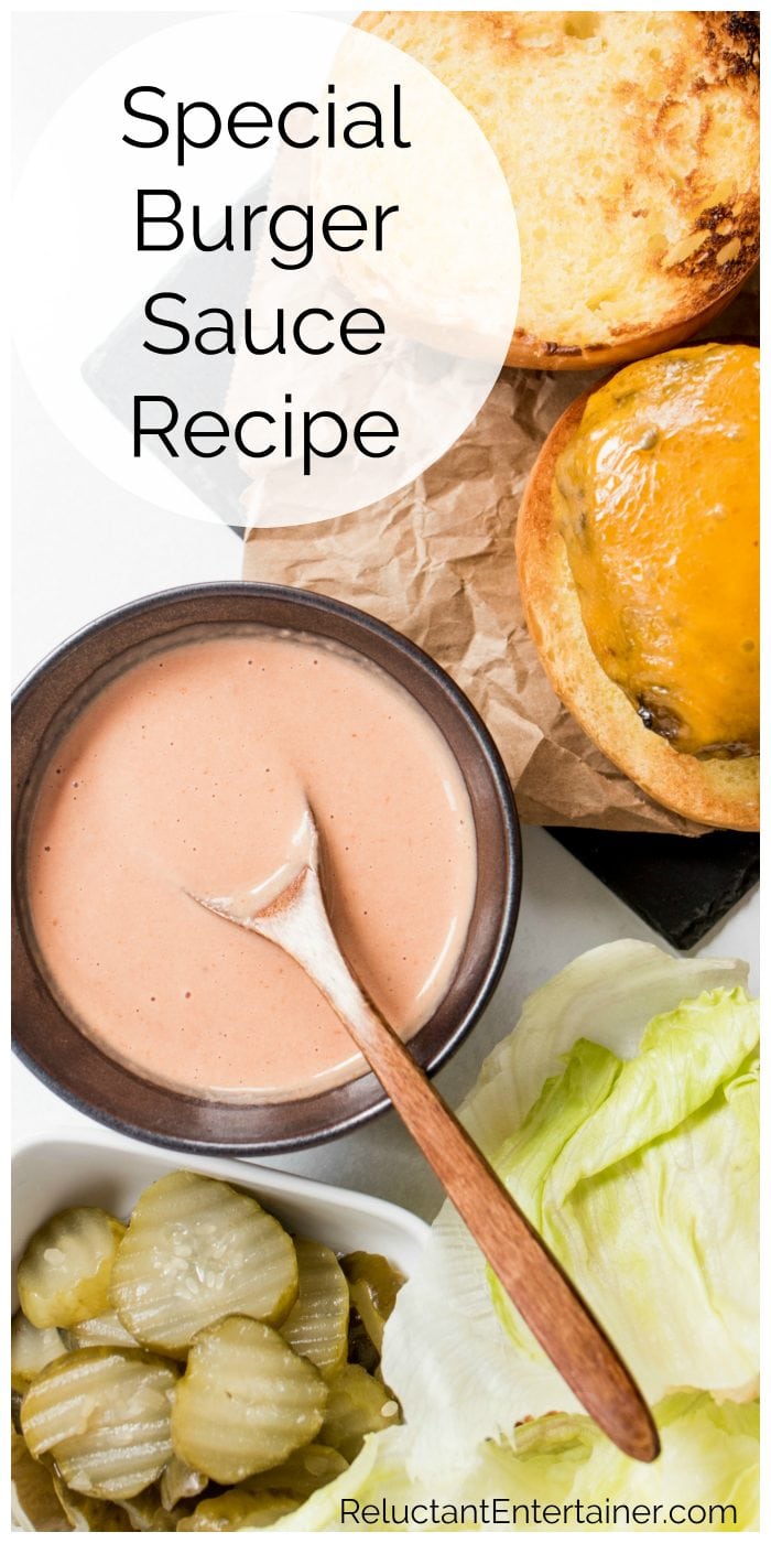 an open face hamburger with a bowl of special burger sauce