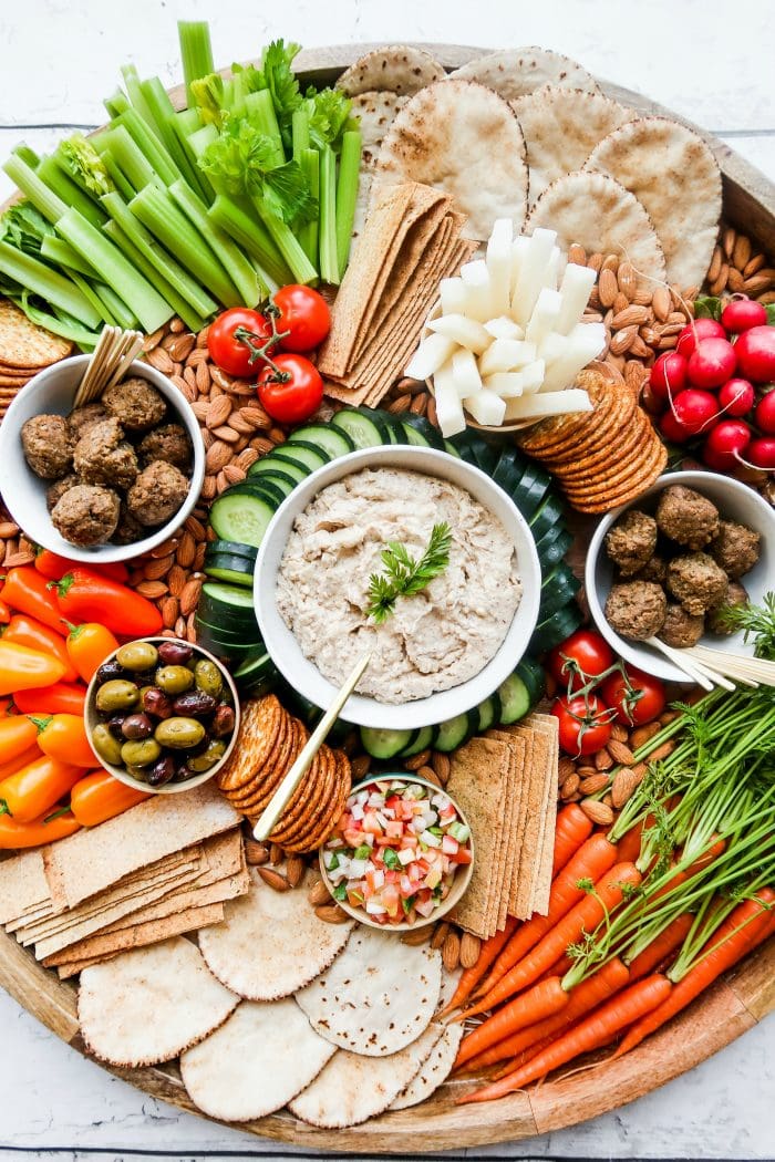 beautiful vibrant crudite spread with a bowl of cashew dip in the center