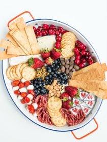 oval tray of cheese and crackers and fruit