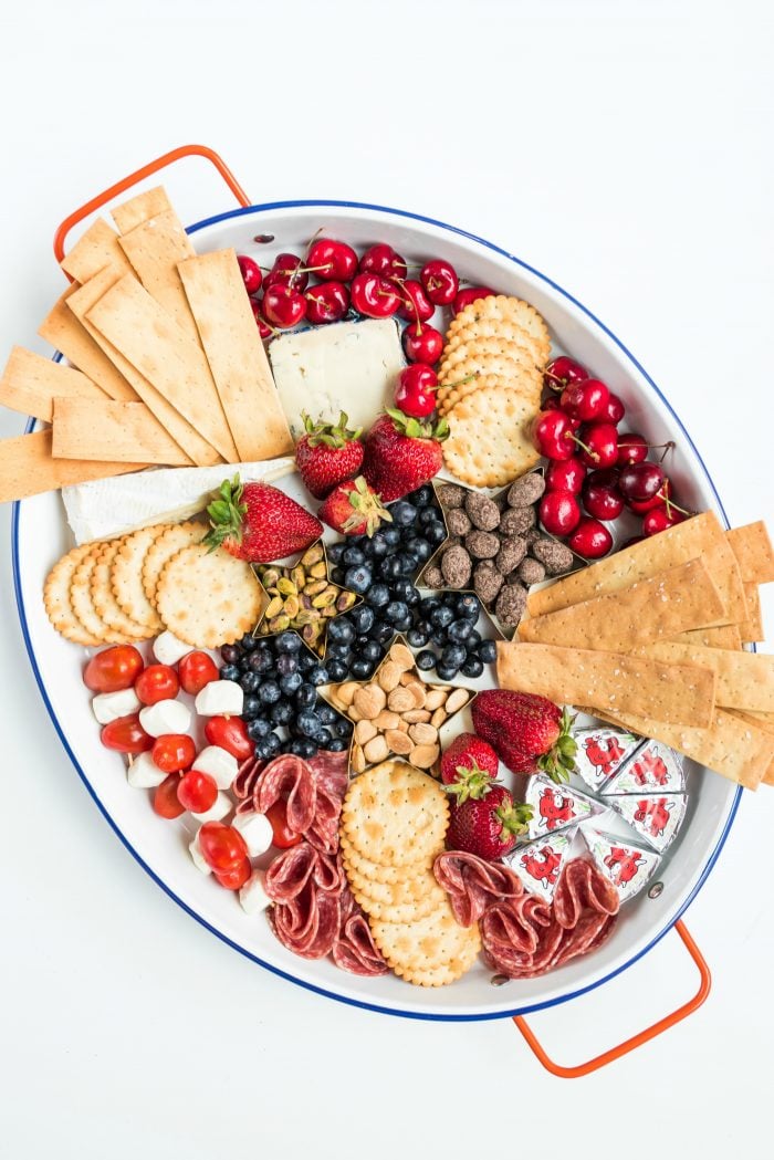 oval tray of cheese and crackers and fruit