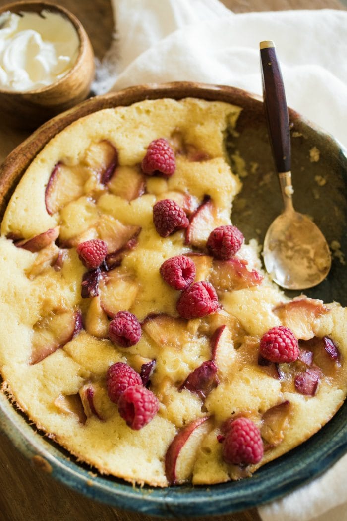 a moist butter cake with peaches and raspberries