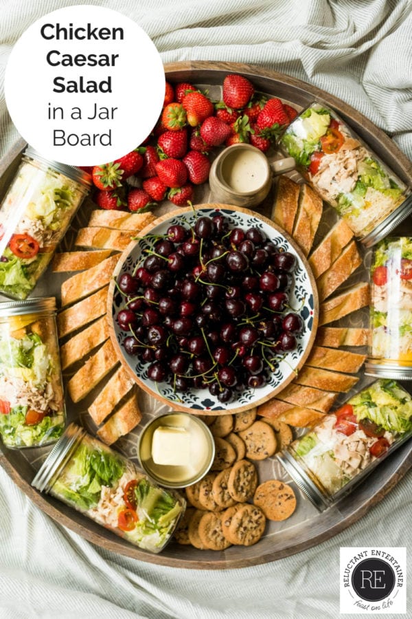 chicken salad in a jar on a dinner board