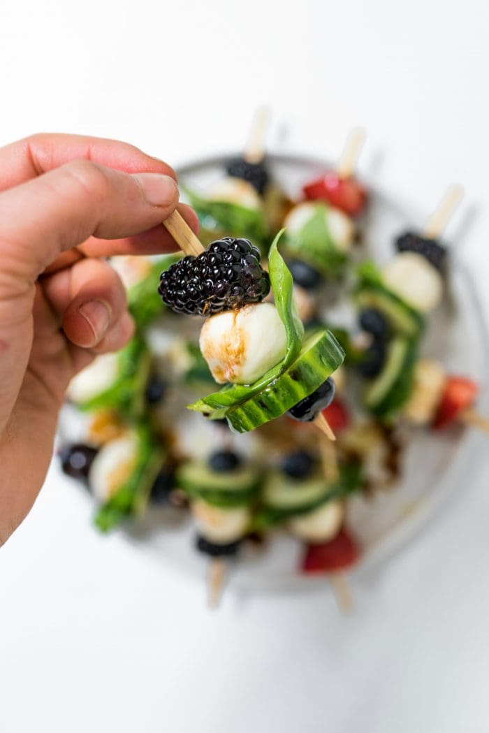 close up Summer Cucumber Bites on a Stick with a whole blackberry