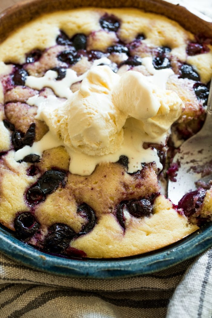 round pan of cherry cake with ice cream