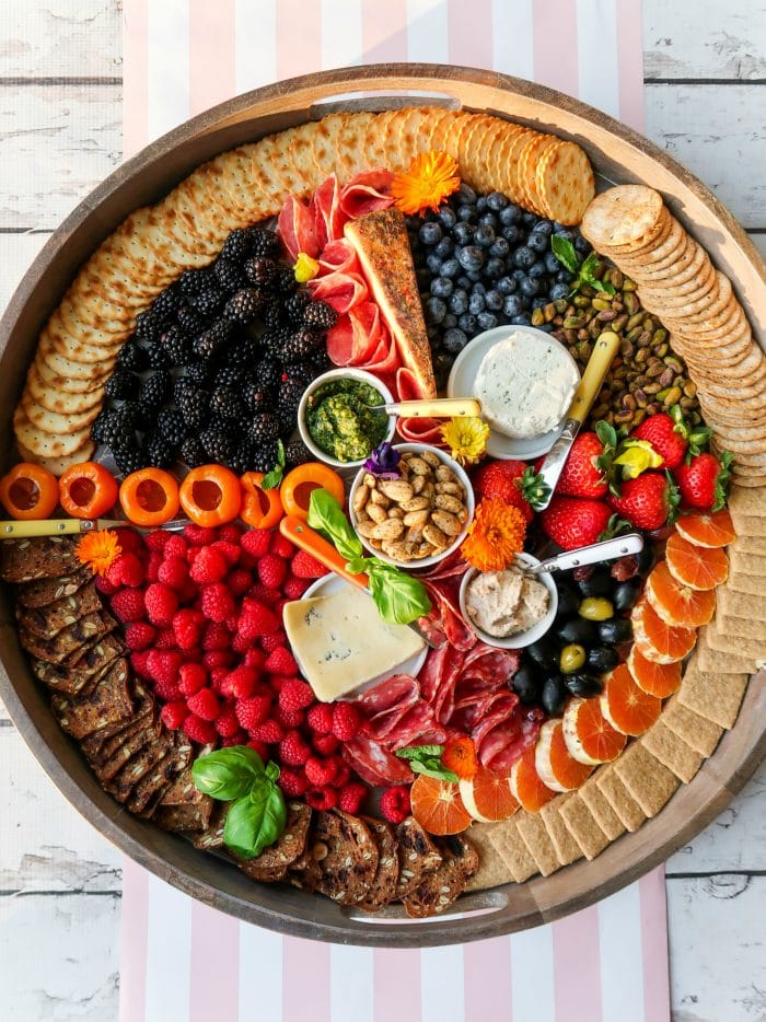 an epic round board filled with colorful foods