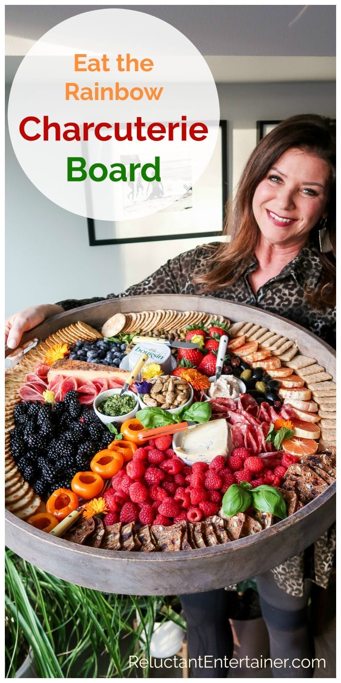 woman holding a big board wil colorful snacks