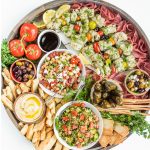 a beautiful round board filled with Summer Mediterranean food