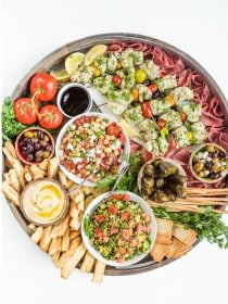 a beautiful round board filled with Summer Mediterranean food