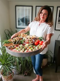 a woman holding a Summer Mediterranean Board