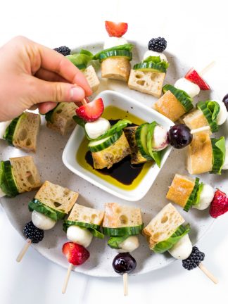 a beautiful plate of Mini Focaccia Sandwich Bites dipped in oil and balsamic